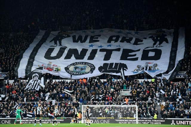 Newcastle fans display a large banner in the crowd ahead of the English Premier League football match between Newcastle United and Aston Villa (Photo by OLI SCARFF/AFP via Getty Images)