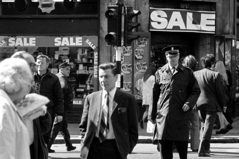 Pedestrians/jaywalkers - and a traffic warden - cross against the lights in Argyle Street Glasgow, August 1974.