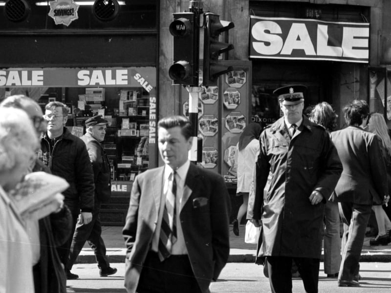 Pedestrians/jaywalkers - and a traffic warden - cross against the lights in Argyle Street Glasgow, August 1974.