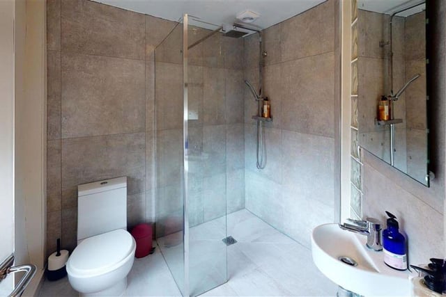 A wet room with a walk-in shower.