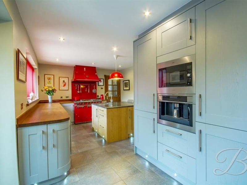 The bright and spacious kitchen. It boasts an island, allowing you to unleash your culinary skills, and a built-in breakfast bar.