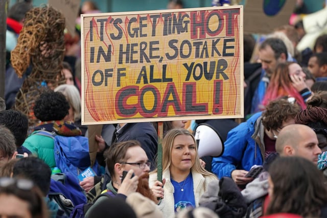 One demonstrator took inspiration from a song by rapper Nelly. Her sign reads 'It's getting hot in here, so take off all your coal'.