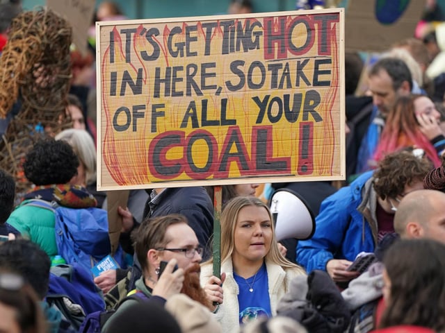 One demonstrator took inspiration from a song by rapper Nelly. Her sign reads 'It's getting hot in here, so take off all your coal'.