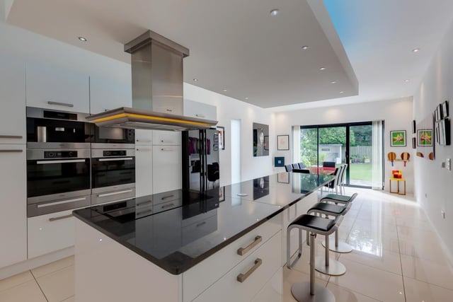 The kitchen contains high-quality Miele appliances, a dropped ceiling light box and porcelain tiled flooring with underfloor heating. A Quooker boiling water tap and a central island add to the extensive inventory - there's even an integrated coffee machine.