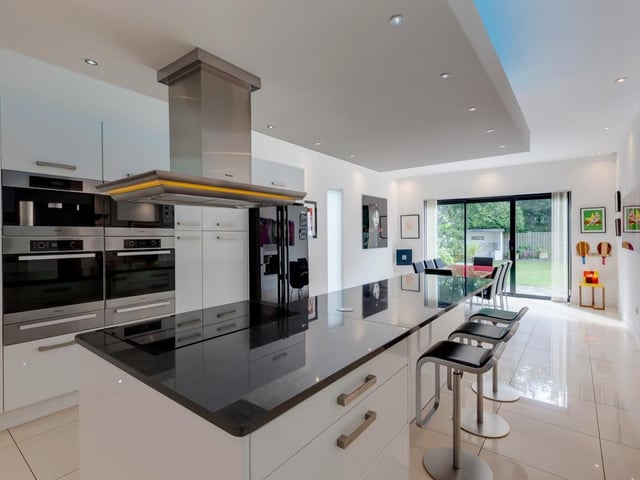 The kitchen contains high-quality Miele appliances, a dropped ceiling light box and porcelain tiled flooring with underfloor heating. A Quooker boiling water tap and a central island add to the extensive inventory - there's even an integrated coffee machine.