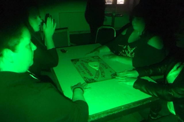 This spooky snap was captured at Thoresby Park in 2019,  just before a ghost hunting team took part in an Ouija board session. According to Lee, the area was said to be haunted by a child that had lived in a nearby village.
Also known as a spirit board, the Ouija board is marked with the letters of the alphabet,  numbers 0–9, and "yes", "no."  It uses a planchette (a small heart-shaped piece of wood or plastic) as a movable indicator to spell out messages during a séance.
