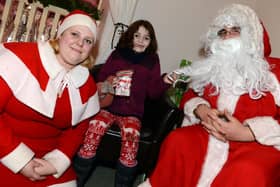 Whirlow Hall Farm held its annual Christmas Fayre, with arts and crafts on sale, a farmer's market and santa's grotto. Our picture shows Alice McGhee, aged five, of Killamarsh, with Santa Alex Haynes and his helper Morgan Haynes.