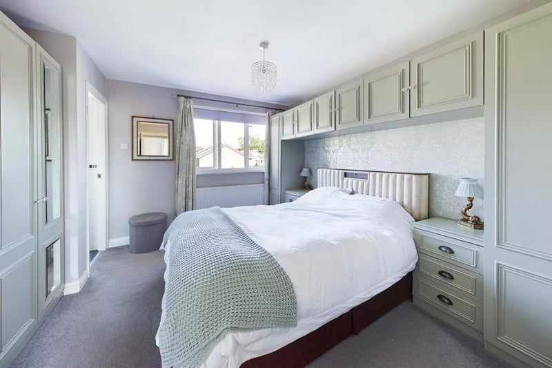 The main bedroom boasts fitted wardrobs and a modern ensuite shower room.