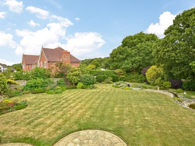The house comes with a manicured Gardens extending 0.53 of an acre - and the garden backs onto woodland.