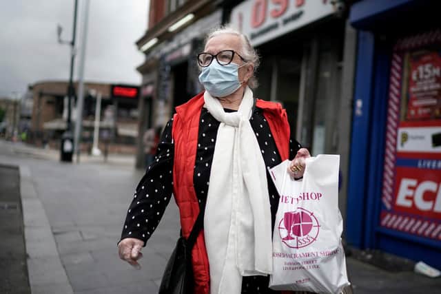 A woman wears a face masks (Photo by Christopher Furlong/Getty Images)
