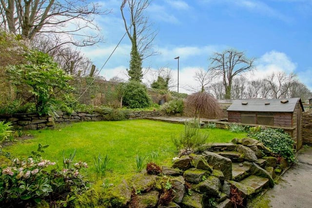 A stone-walled garden sits behind the house.