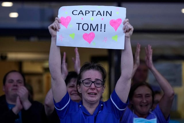 A nurse at Aintree University Hospital sheds a tear and as she pays tribute to Colonel Tom Moore during the "Clap for Our Carers" and the NHS on April 16, 2020 in Liverpool, United Kingdom. (Photo by Christopher Furlong/Getty Images)