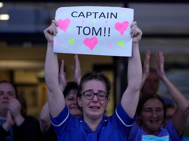 A nurse at Aintree University Hospital sheds a tear and as she pays tribute to Colonel Tom Moore during the "Clap for Our Carers" and the NHS on April 16, 2020 in Liverpool, United Kingdom. (Photo by Christopher Furlong/Getty Images)