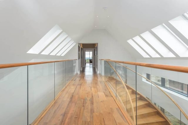 "The contemporary staircase leads to a galleried landing and to the principal bedroom with dressing room and en suite bathroom."