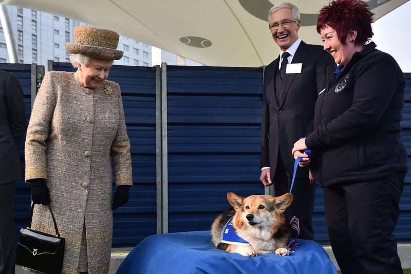 Queen Elizabeth II and Paul O’Grady during a visit to Battersea Dogs and Cats Home in London.