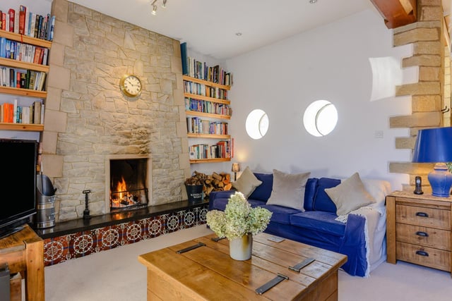 The sitting room has access to a cloakroom, lift and has a feature fireplace and porthole windows.