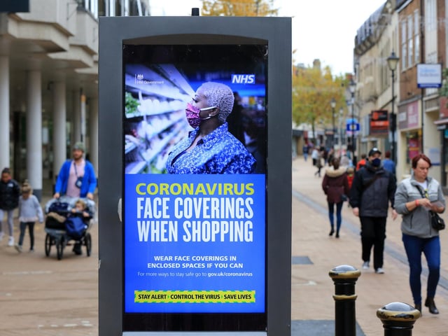Signs reminding people to wear face masks in the town centre