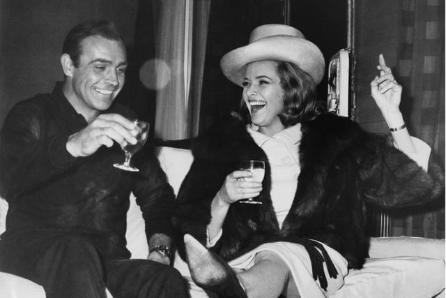 Scottish actor Sean Connery and English actress Honor Blackman enjoy themselves during a break in filming the James Bond movie 'Goldfinger' at Pinewood Studios, UK, 25th March 1964.