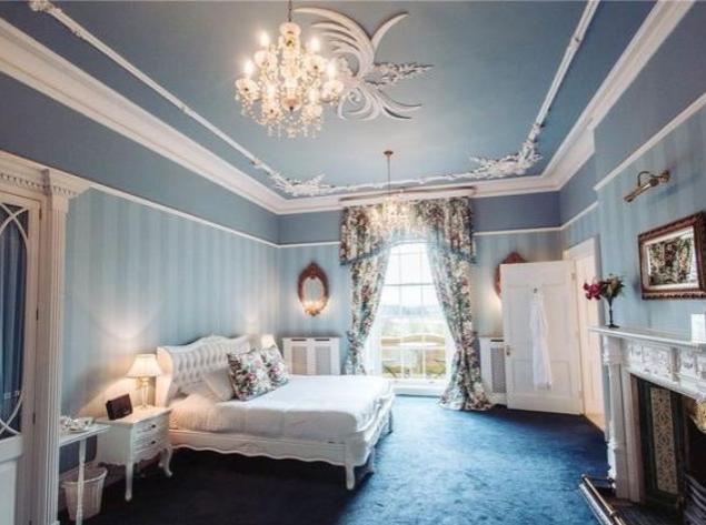 An outstanding cantilevered staircase rises to two floor landings leading access to twelve spacious double en-suite bedrooms, six on each floor. One additional en-suite bedroom can be found in the tower, accessed via a separate staircase and leading to a roof terrace. Each of the thirteen bedrooms has a unique story and period charm which depicts the wonderful history of this magnificent house, simultaneously offering modern luxurious amenities.