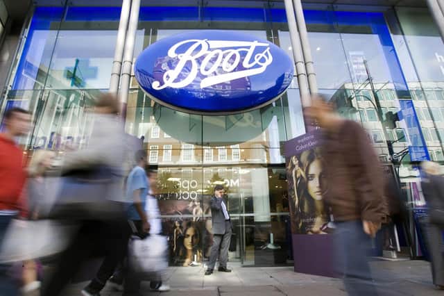 Passers-by walk in front of a Boots Store (Photo credit should read Leon Neal/AFP via Getty Images)