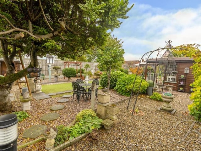 Trees and a selection of ornaments add to the appeal of the garden at the Abbott Road property.