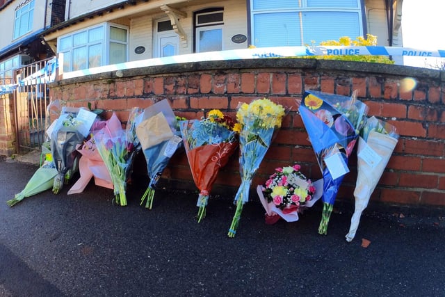 Flowers and messages of condolences have been left outside the couple's home
