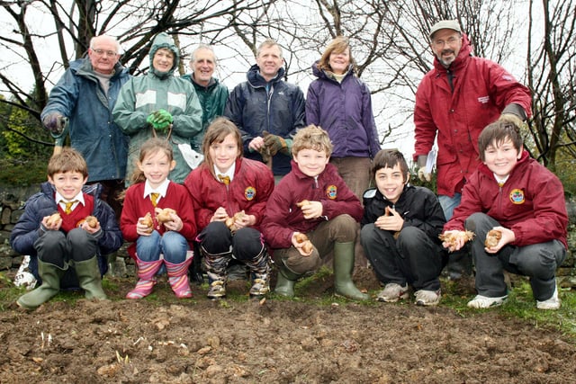 Matlock's StJoseph's Catholic Primary School pupils Ciaran Healy, Charlotte Haworth, Chloe Brown, Oliver Grant, Thomas Dunne-Wragg and Declan Farrand  are joined by members of the Matlock Civic Society to  plant crocus and daffodil bulbs outside their school in 2019.