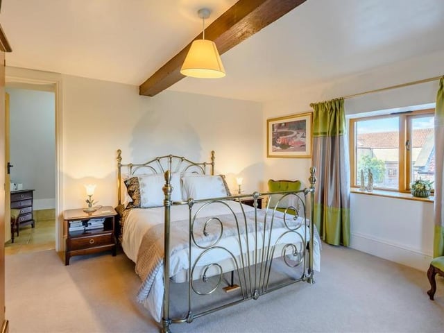 This bedroom beams in more ways than one. It is a pleasant room, offering spectacular views, and it also has a central beamed ceiling.