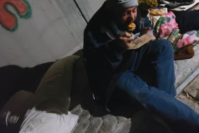 A homeless man tucks into food provided by Tracey, Dolah and their fellow volunteers in Benidorm