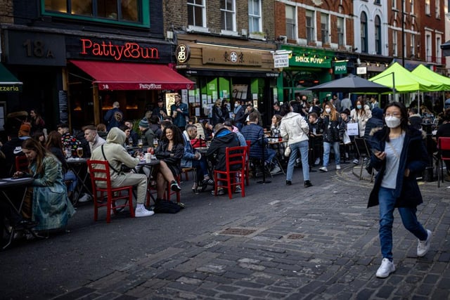 People enjoying food and drinks at tables set out in the street in Soho on April 16, 2021 in London, England. (Photo by Rob Pinney/Getty Images)