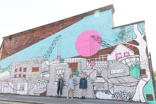 Jo Peel, centre, with fellow artists Fem Sorcell, left, and Radha Ferris, right, in front of her Alma Street mural