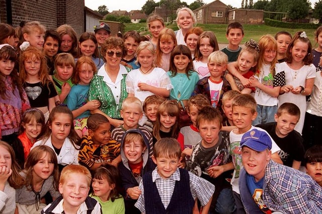 Dorothy Bell, retiring headteacher of Mansel Primary School, pictured with some of the pupils from the school (July 1996)