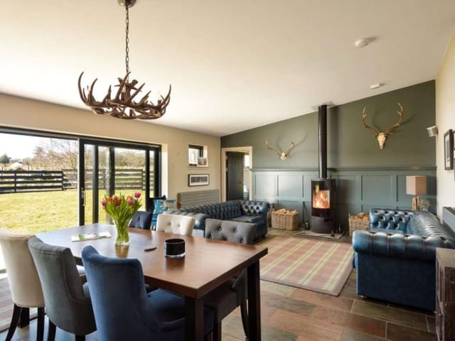 The heart of the home is encapsulated by the open plan dining area and living room, which gets flooded with natural light from the large patio doors