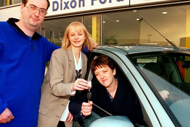 Marie Tate (centre) Dixon Ford Marketing & Communications Co-ordinator hands over the keys of a new Ford Focus to Lynn & Steve Jones of Cantley, Doncaster in 1999