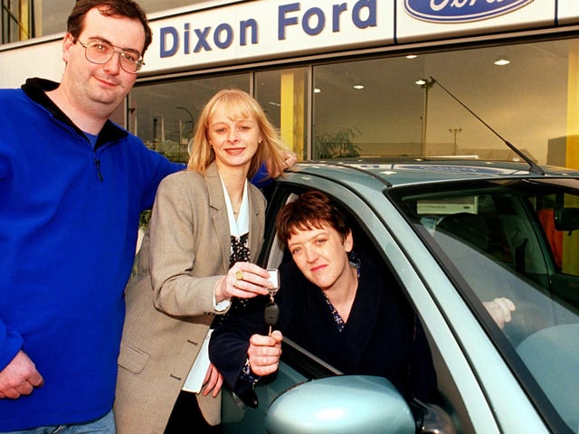 Marie Tate (centre) Dixon Ford Marketing & Communications Co-ordinator hands over the keys of a new Ford Focus to Lynn & Steve Jones of Cantley, Doncaster in 1999