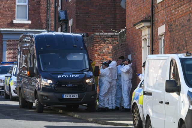 Forensic officers pictured in Marshall Wallace Road on Saturday.