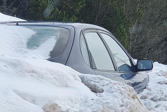 A car almost completely covered in snow spotted at the side of the A9 road yesterday afternoon.