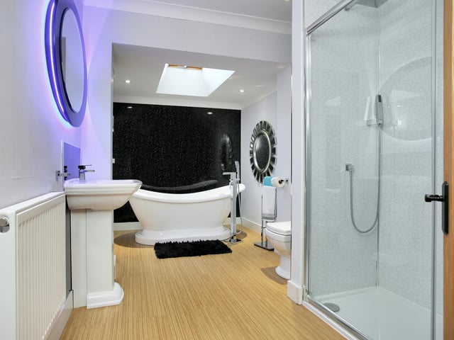 The bathroom has a roll-top bath and a seperate shower.