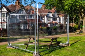 A fenced off picnic table in a recreational space; taped-off benches and other "social distancing" markers have become common (Photo: Peter Dench/Getty Images)