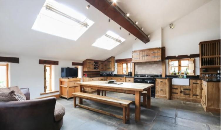 The bespoke oak kitchen has solid granite worktops and s Sandyford range oven.