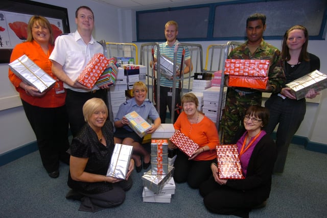 Post Office workers at Pond Street handover shoe boxes to the armed forces as part of a charity event in 2010