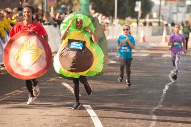 A team of runners in the junior girls race cross the finishing line - dressed as ham and cheese and a sliced avocado. Photo: Gary Tiller