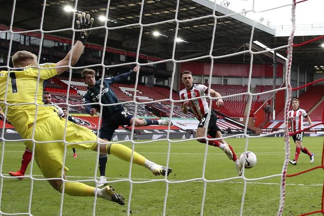 Sheffield United's goalkeeper Aaron Ramsdale, left, fails to make a save against Leeds United's Patrick Bamford, 2nd left, during the English Premier League soccer match between Sheffield United and Leeds United at Bramall Lane stadium in Sheffield, England, Sunday, Sept. 27, 2020. (Alex Livesey/Pool via AP)