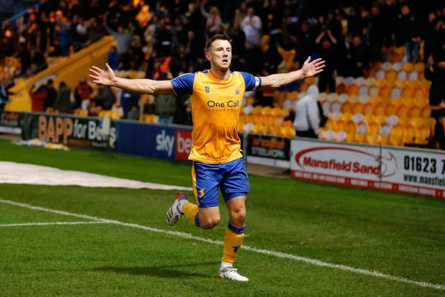 Captain Oli Clarke runs towards the Mansfield fans after netting his second goal of the match.