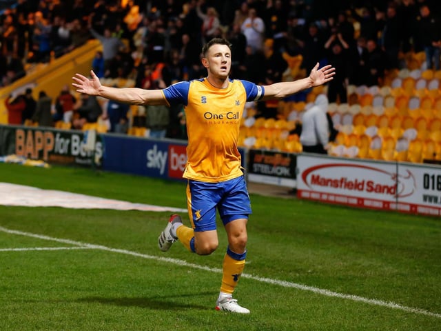 Captain Oli Clarke runs towards the Mansfield fans after netting his second goal of the match.