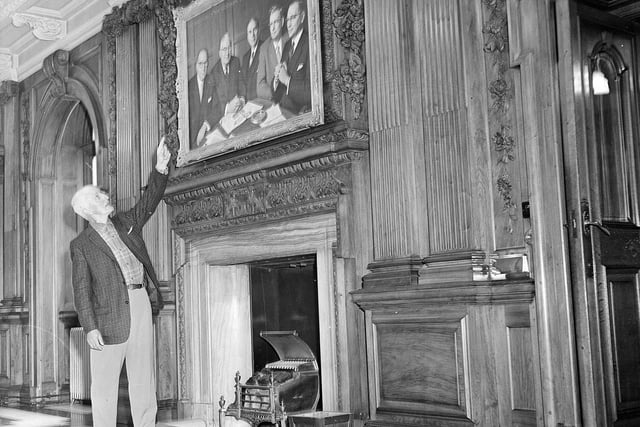 William Robb admiring wood carvings made by his brother in The Scotsman office's Walnut Hall in June 1961.