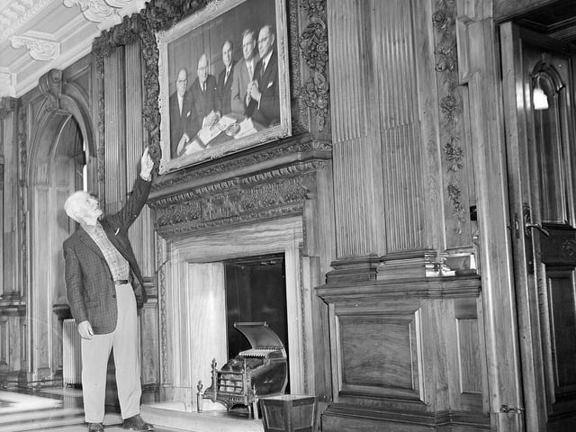 William Robb admiring wood carvings made by his brother in The Scotsman office's Walnut Hall in June 1961.