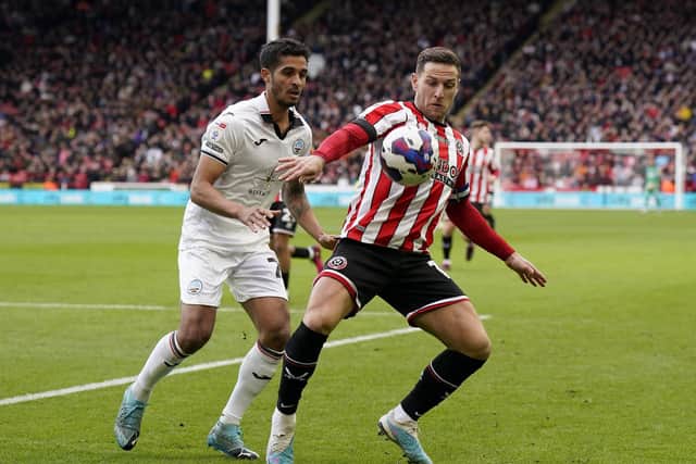 Billy Sharp in action against former Sheffield United player Kyle Naughton, now of Swansea City: Andrew Yates / Sportimage