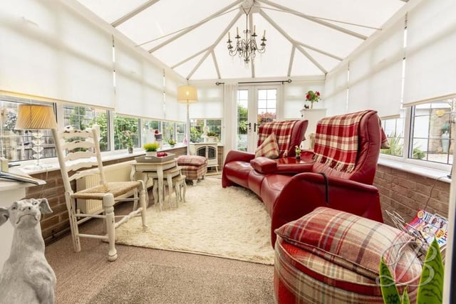 The home's conservatory boasts size and light. It has a carpeted floor, a central-heating radiator and windows overlooking the back garden. Double doors lead outside.