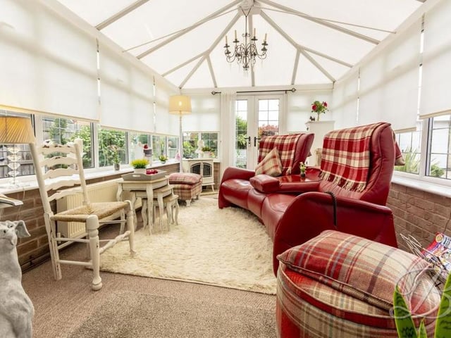 The home's conservatory boasts size and light. It has a carpeted floor, a central-heating radiator and windows overlooking the back garden. Double doors lead outside.
